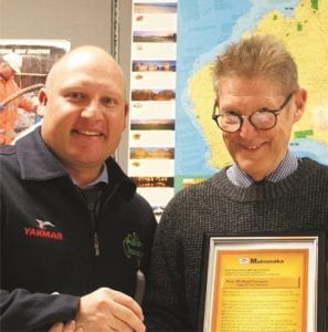 Warwick Lorenz (left), Australian Pumps Managing Director, awards Bradley Farrugia the 20 year Order of Merit certificate.