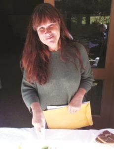Theresa Neely cutting cake