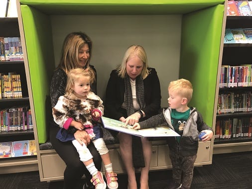 Twins Olivia and Maximilian in the new book nook with grandmother Angela and Hills Shire Mayor Michelle Byrne