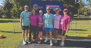 Group of people participating in a charity run for cancer research in Galston.