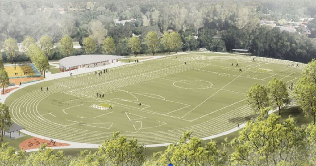 New sports field with running track and sports facilities in a green park setting.