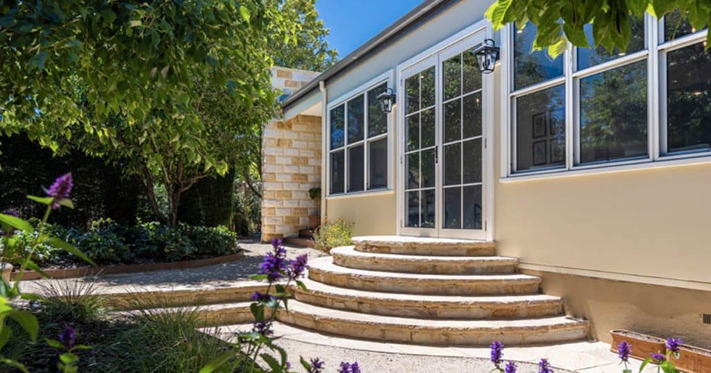 Beautiful backyard with curved steps and lush greenery in Galston, Hills Rural Community.