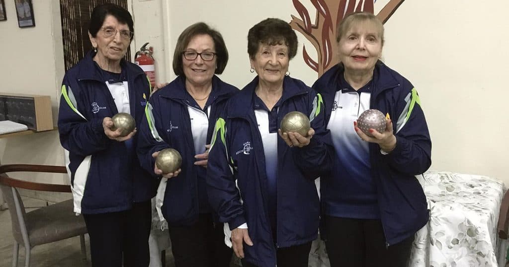 Women holding lawn bowls at Dural Bocce Club event.